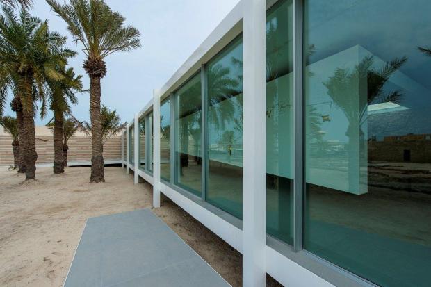 13-6-Marco Boria-glass wall giving a view out to sea and the manama skyline